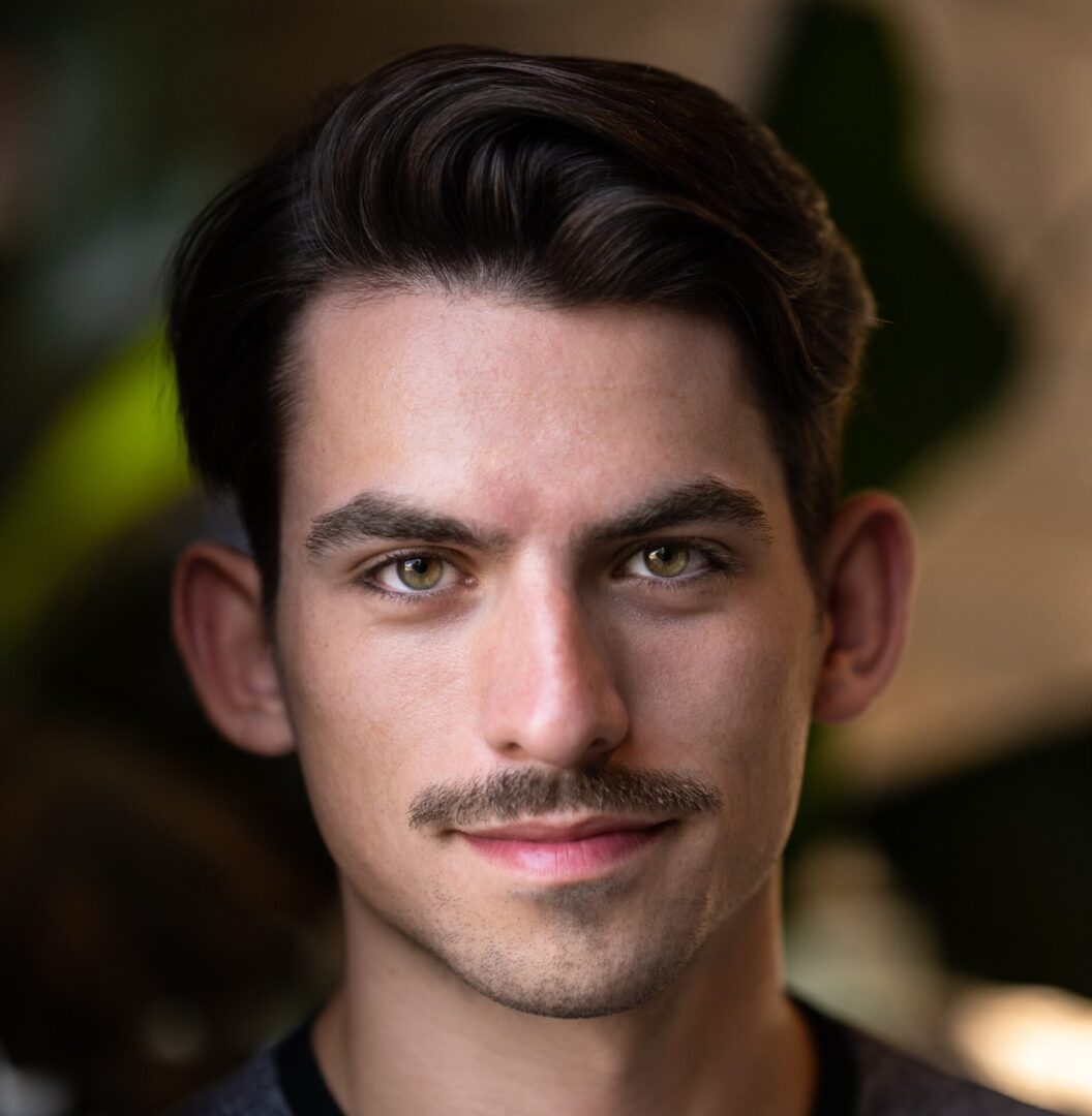 Close-up portrait of a man with a mustache.