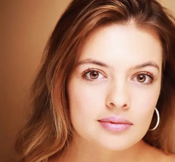 Close-up portrait of a woman with brown hair.