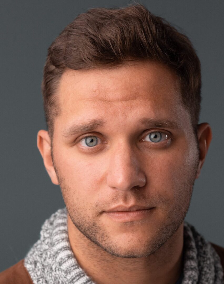 Close-up portrait of a man with blue eyes.