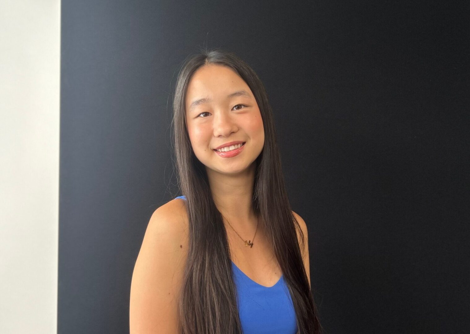 Smiling woman with long black hair.