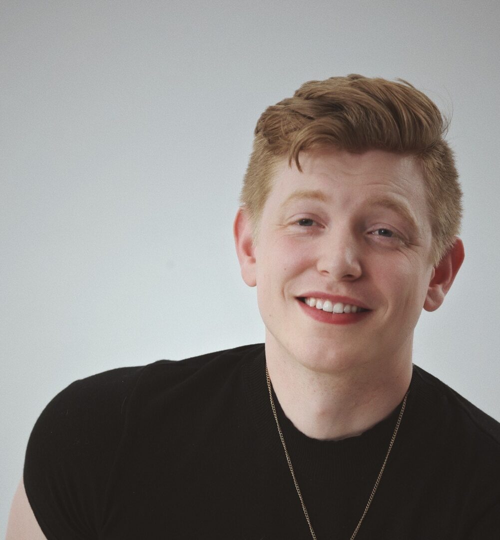 Smiling man wearing a black shirt.