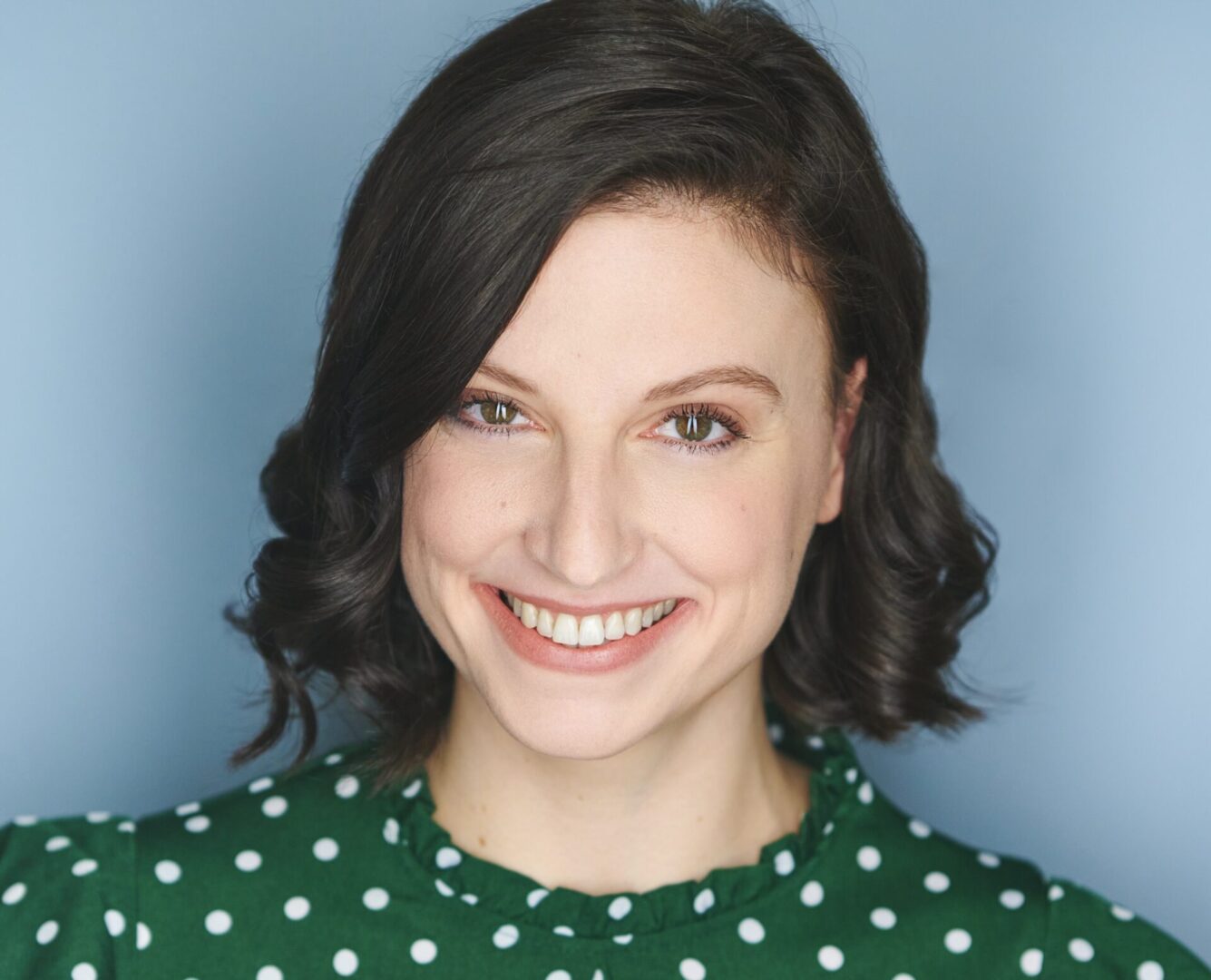 Smiling woman with short brown hair.